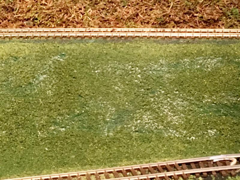 Techniques for applying grass or flock to hillsides. Model Railroad